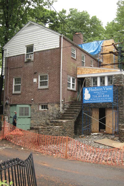 A new set of stone steps inspired by the site's natural rock outcroppings leads to the renovated kitchen.